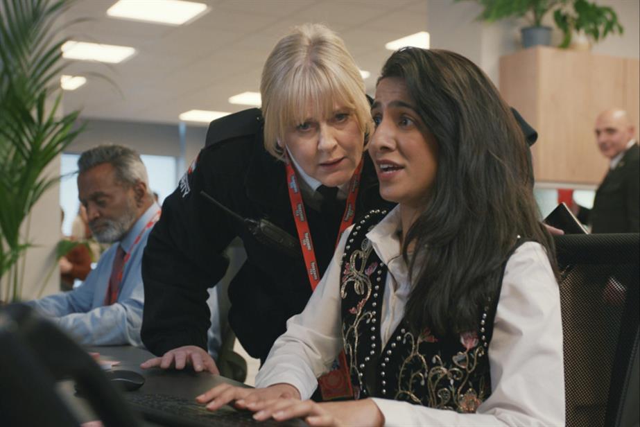 Sarah Lancashire interrogating an office worker