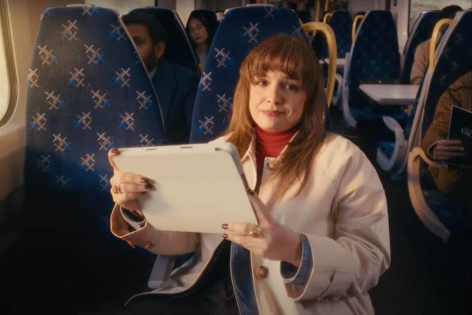 Woman on train with tablet