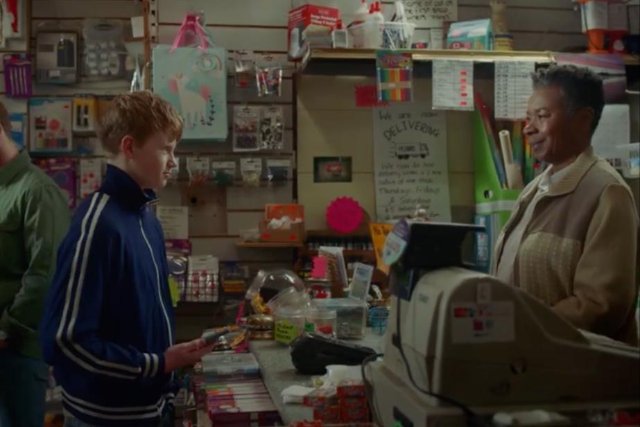 Boy in a shop across from a cashier