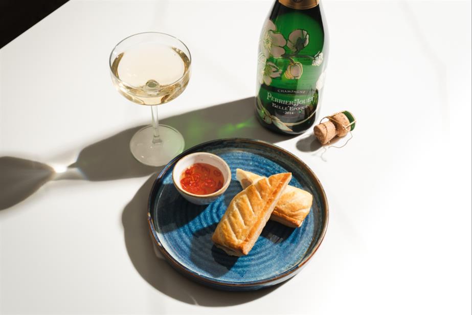 Greggs sausage roll and champagne