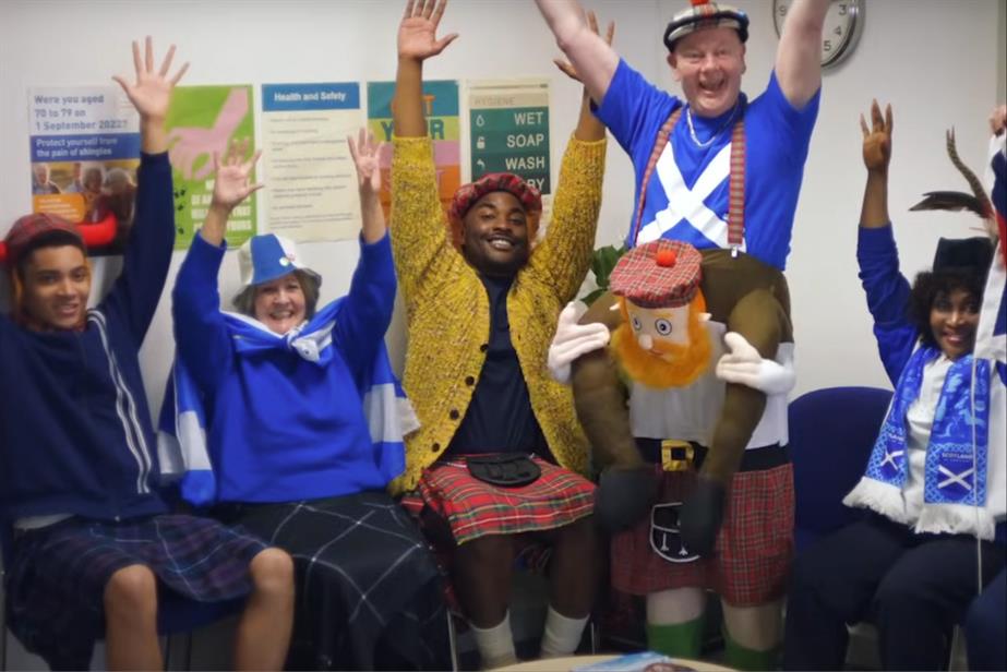 People celebrating in a surgery wearing Scottish clothing