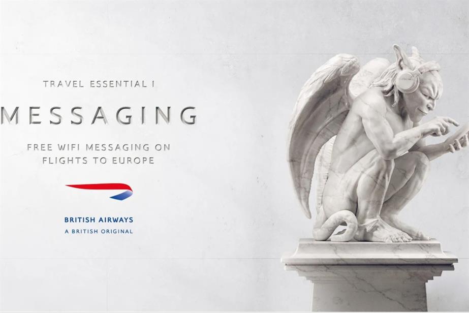 A statue of a gargoyle holding a smartphone