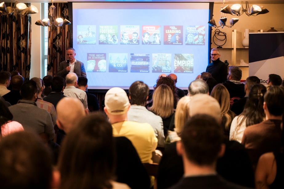 Tony Pastor and Gary Lineker on stage in front of an audience