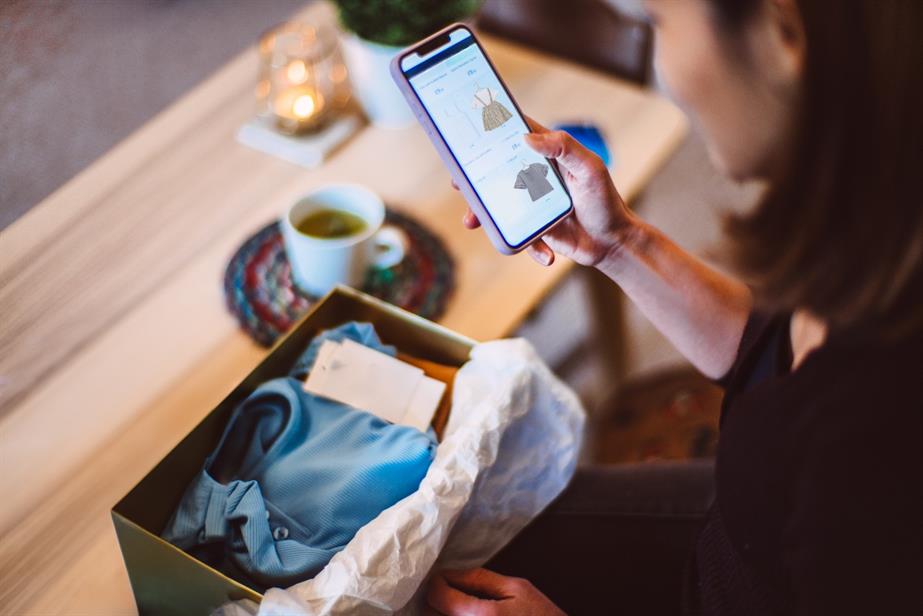 An image of a woman online shopping on her phone.