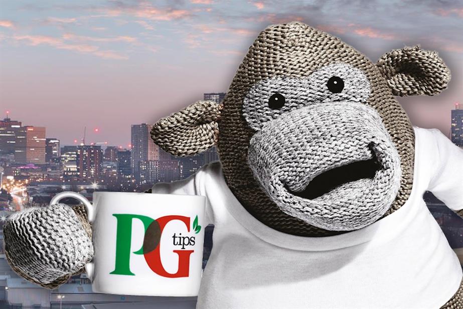 A monkey puppet holding up a cup PG Tips tea