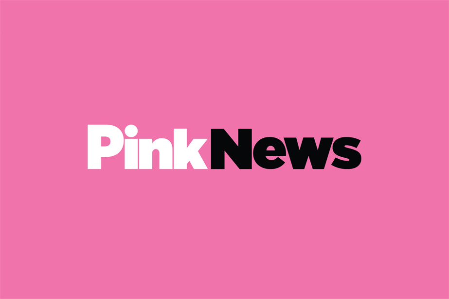 A white and black PinkNews logo on a pink background