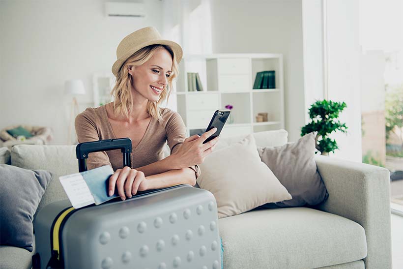 Woman with suitcase and phone