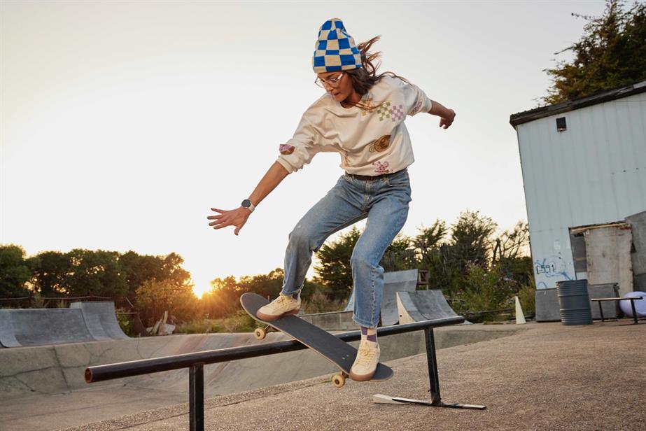 A woman on a skateboard performing a grind