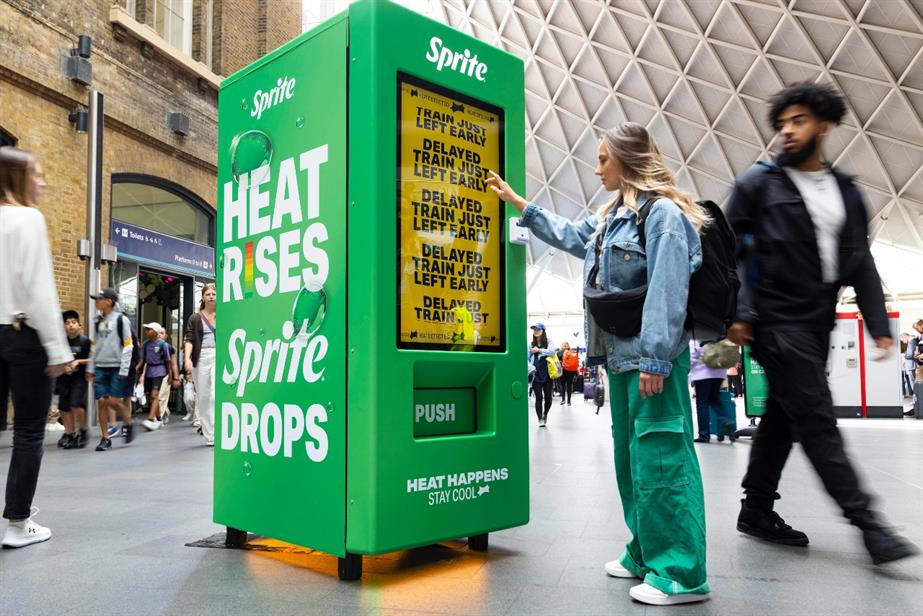 A young woman stands in front of the Sprite vending machine