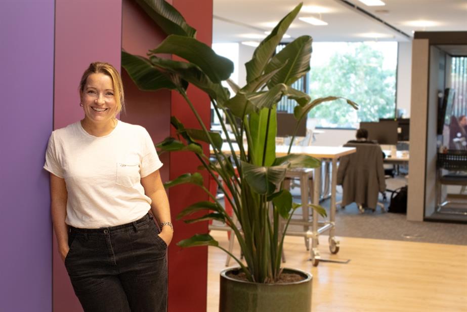 Sannah Rogers, Zenith UK's new chief executive, leans against a wall in the Zenith UK offices. 