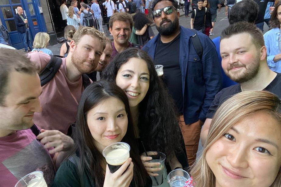 A group of people outside a pub smiling at the camera