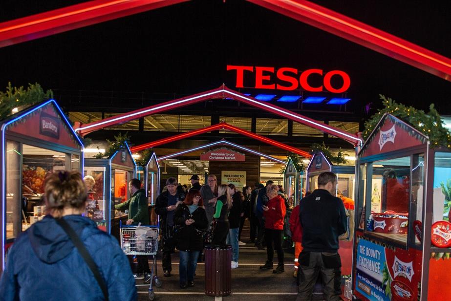A Christmas market with the Tesco logo in the background