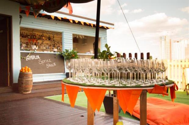 The Aperol Spritz space includes a market stall that serves snack food 