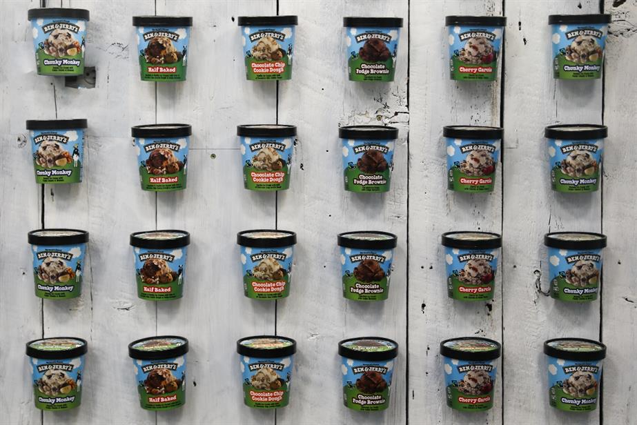 Tubs of Ben & Jerry's hung in front of a wall.