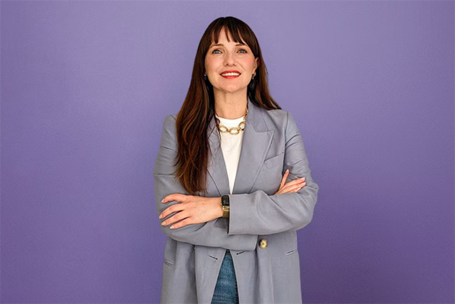 Charlotte Black posing against a purple background
