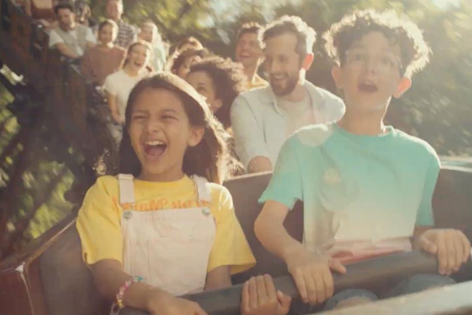 Kids having fun on a rollercoaster at Merlin Entertainments theme park