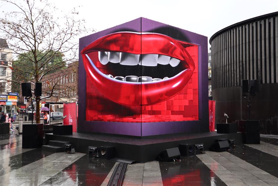 A photograph showing the animated mouth installation outside a wet King's Cross