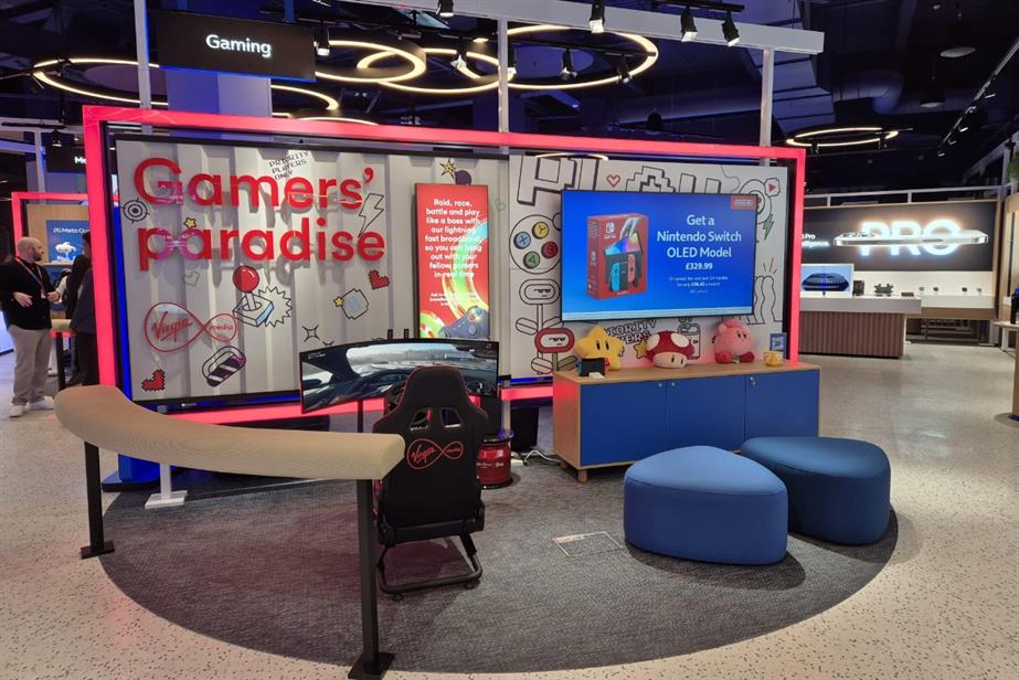 A shop section called “Gamers’ paradise”. A chair sits in front of a curved screen and a TV screen advertises a Nintendo Switch above Mario Bros. toys. 
