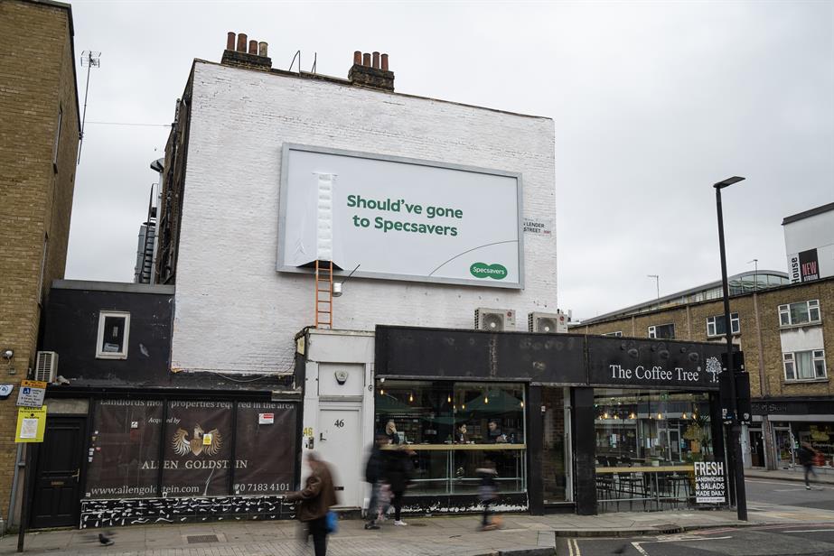 A "should've gone to Specsavers" ad plastered over a ladder on the side of a wall