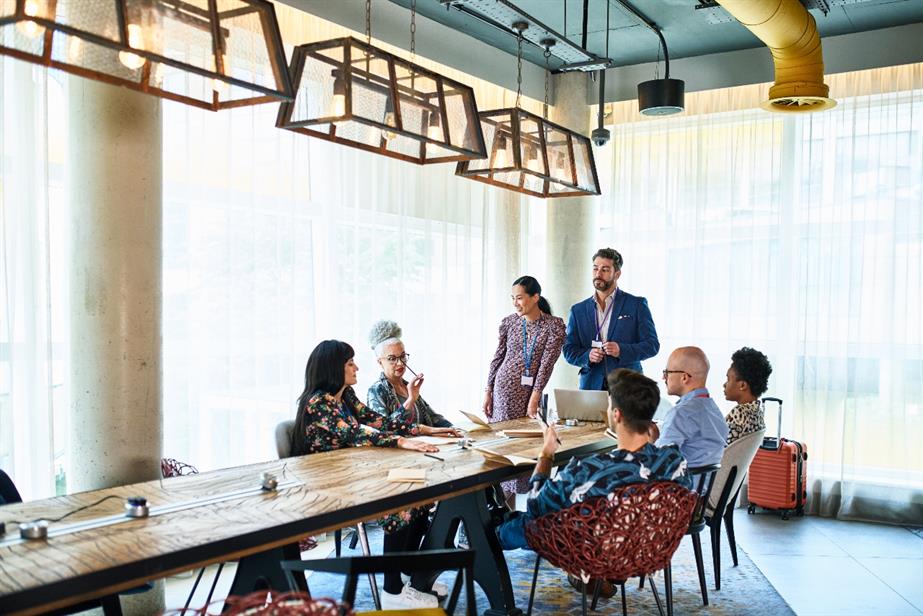 A group of colleagues sit around a table.