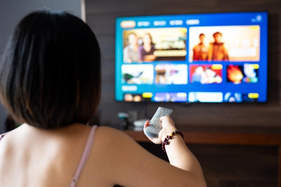 A woman watches TV.
