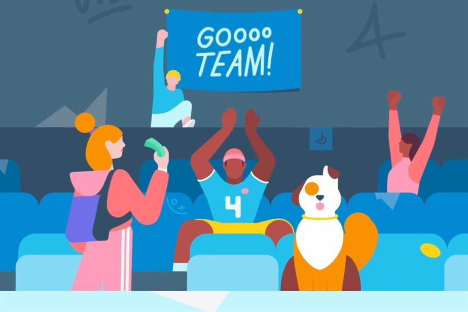 People cheer for a team on the sidelines of a pitch.