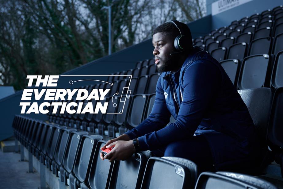 Nathan Owolabi sitting on the Bromley FC terrace, Xbox controller in hand, while copy reads: 'The everyday tactician'