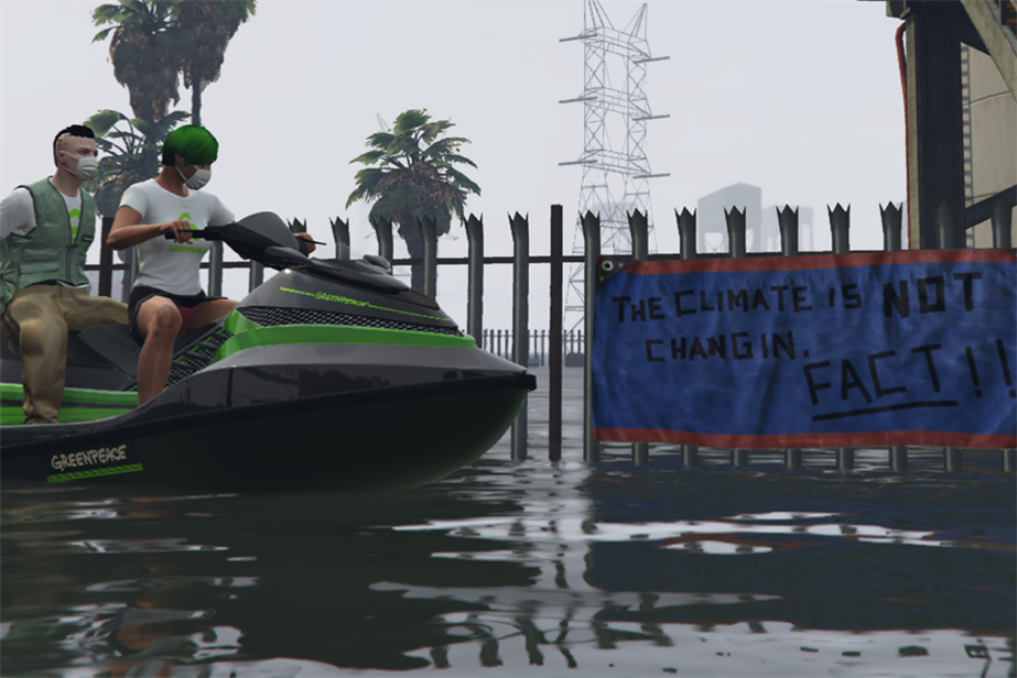 Men riding a speedboat with the Greenpeace logo across a flood with a banner saying: The climate is not changin, fact!