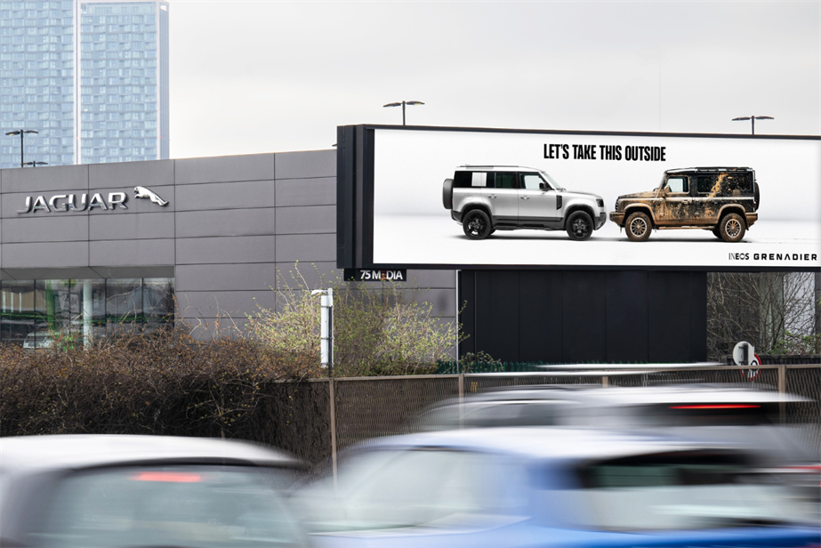 Ineos Grenadier car towing a billboard