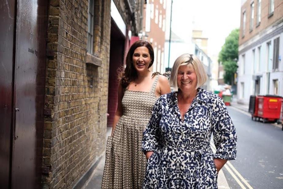 Craft Media's Jenny Jones and Sally Weavers stand on a street in London, laughing.