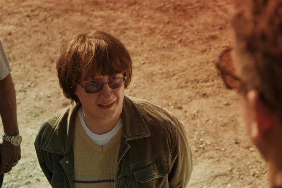 Still from Domino's ident of a man on his knees looking up at someone