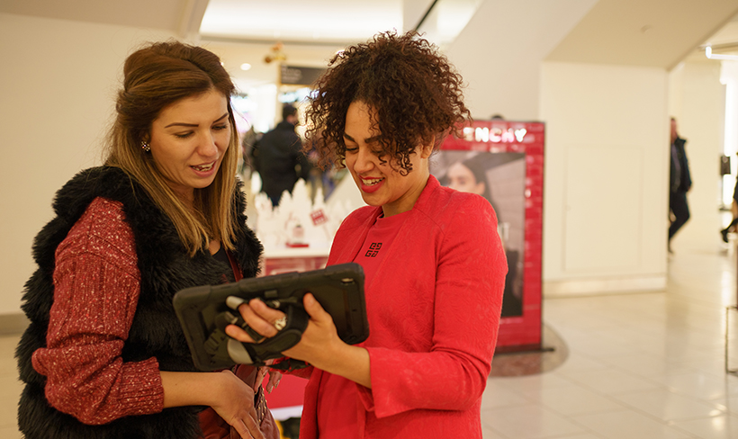 two women looking at tablet