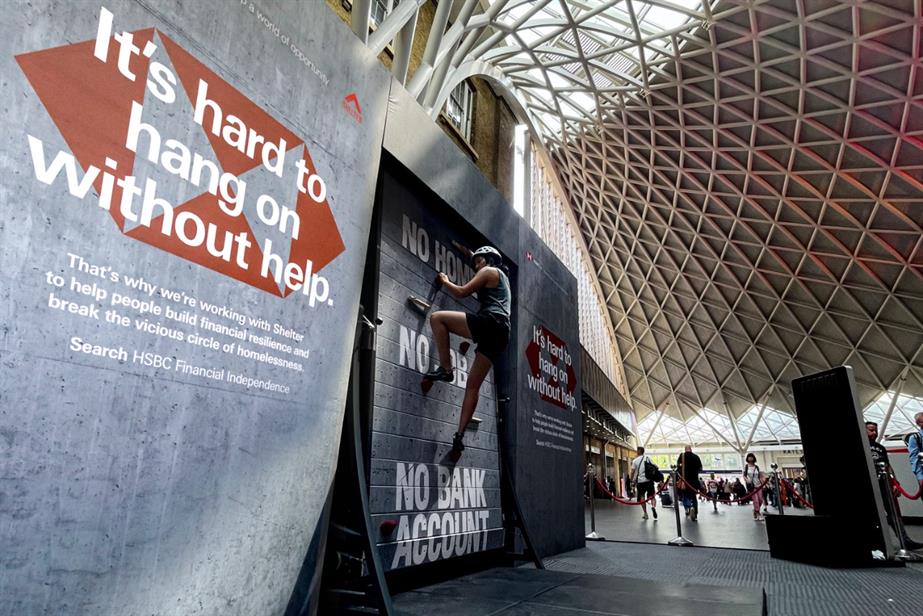 Actor climbing HSBC and Shelter rotating wall