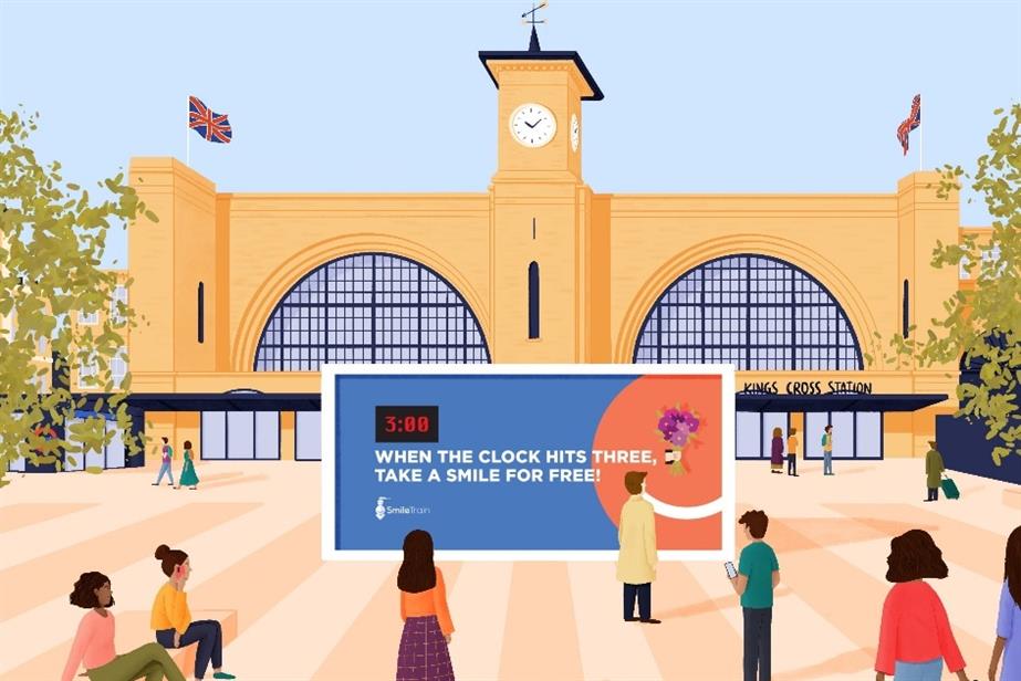 A stylised illustration of a Smile Train billboard outside London's King's Cross station