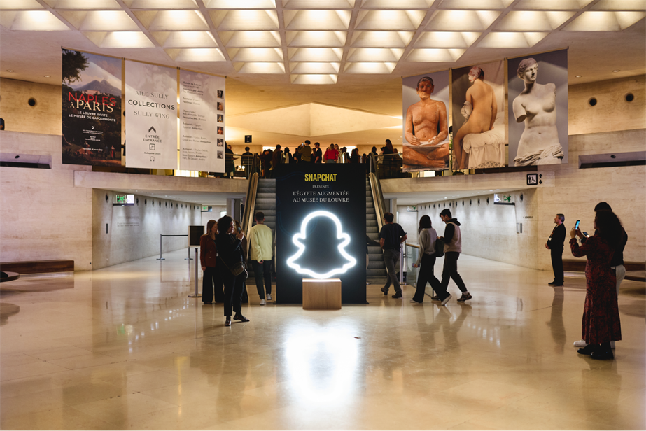 Luminous Snapchat ghost logo at the Louvre museum in Paris