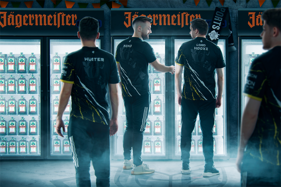 Promotional graphic for the Jägermeister and G2 Esports partnership, depicting G2 esports players standing in front of fridges containing Jägermeister products