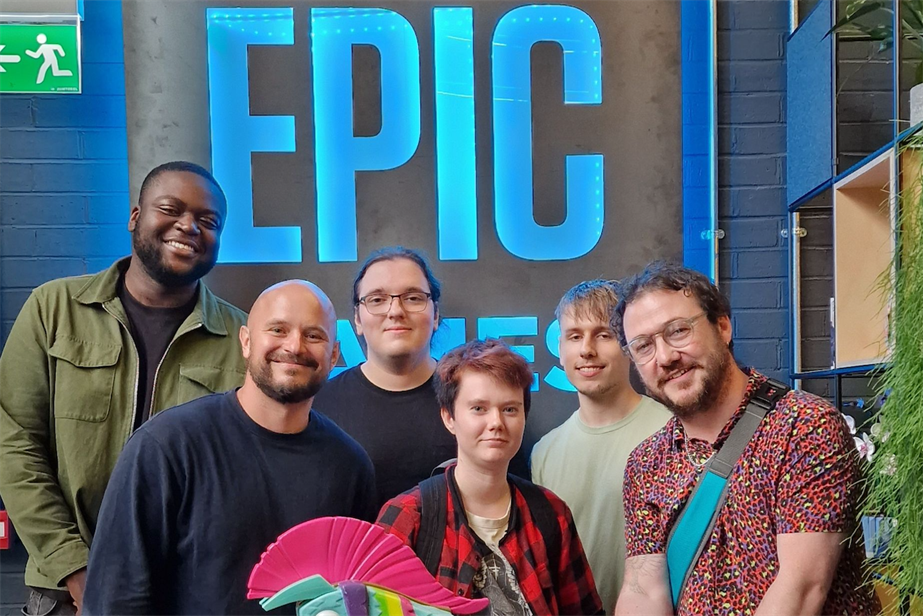 Pictured: Karta Fortnite Studio's team, standing in front of an Epic Games logo