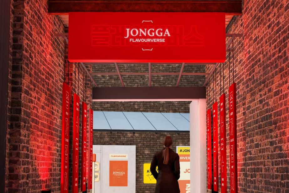 A woman stands under a red sign which reads "Jongga Flavourverse"