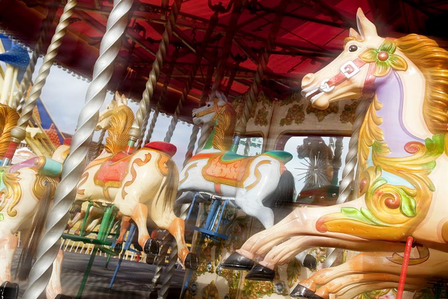 A merry-go-round with wooden horses