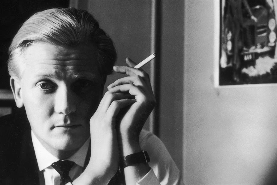 Black and white portrait shot of a young Michael Heseltine smoking a cigarette