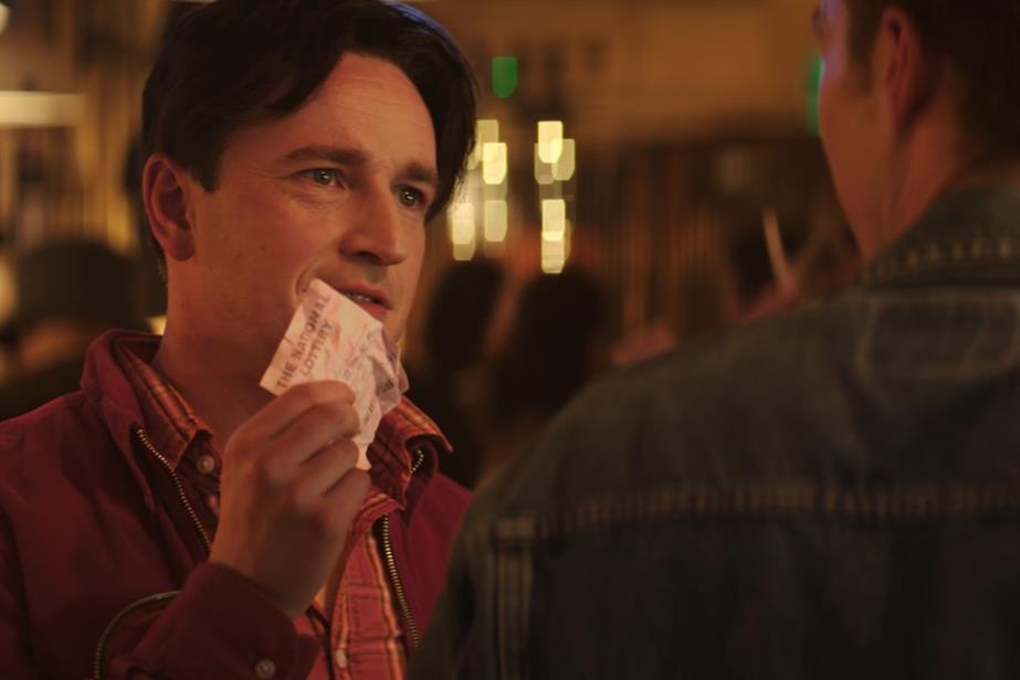 Man holding lottery ticket