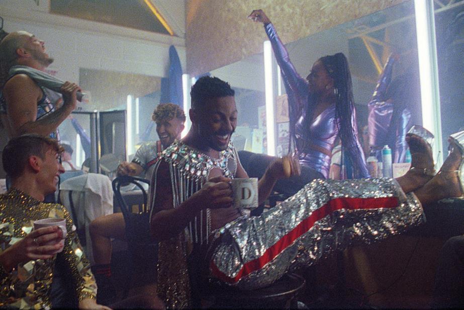 People in a dressing room in sparkly costumes drinking cups of Tetley tea