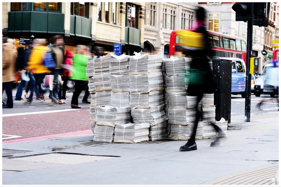 Newspapers piled up on a street