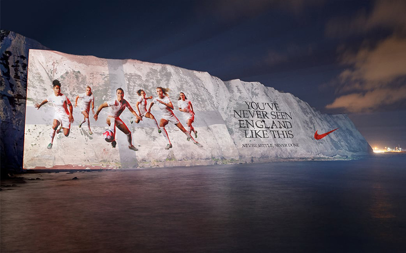 white cliffs with England women's football team projected onto them and Nike logo