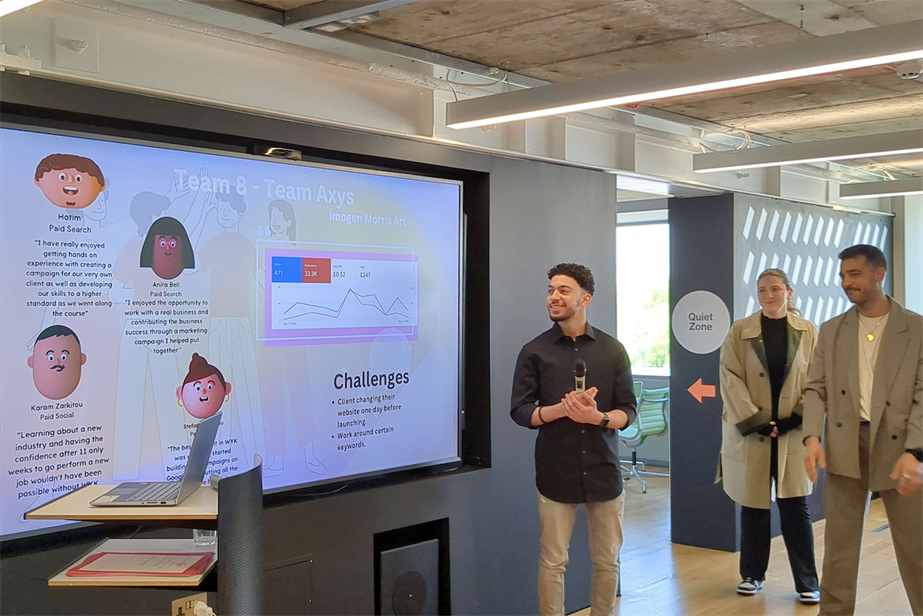 Photo of young trainees engaging in a presentation at OMG and WYK Digital's placement programme