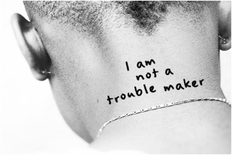 Woman's neck with the words I am not a troublemaker 