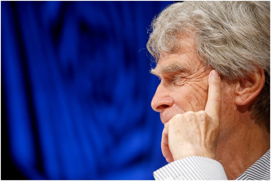 Profile of Sir John Hegarty against a blue backdrop 