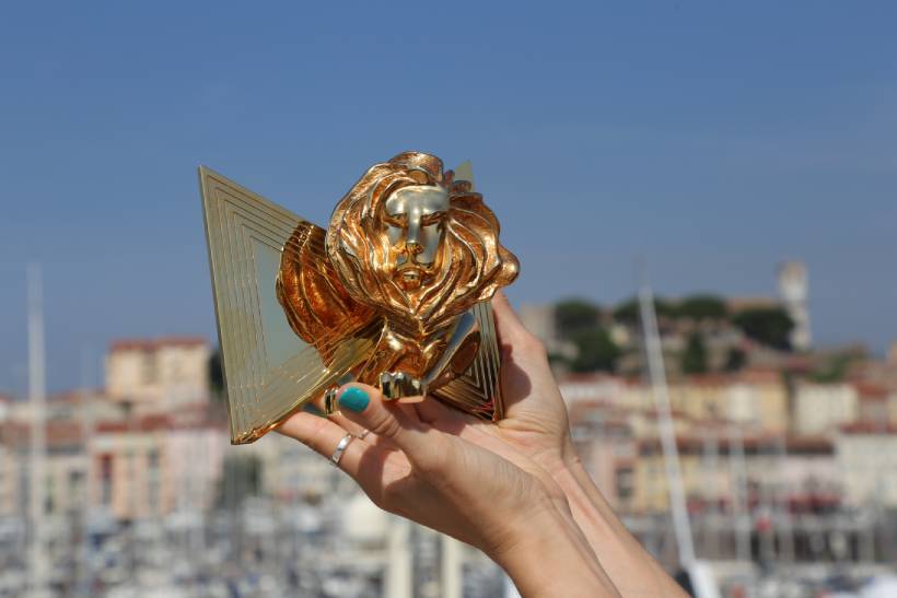 hand holding a cannes lion award