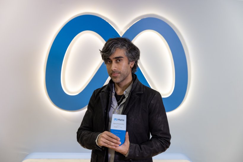 man with Meta trophy