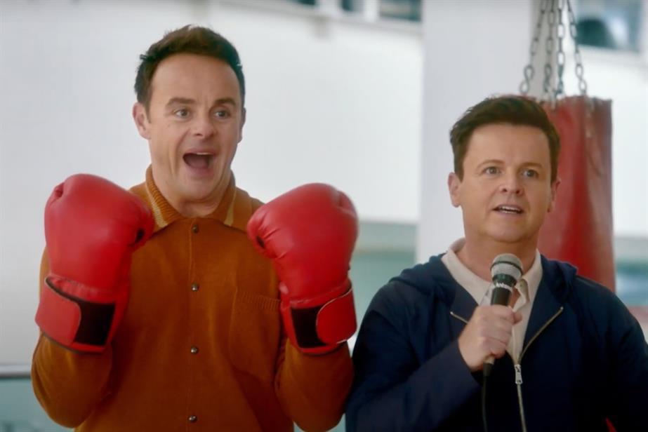 Ant wearing boxing gloves and Dec speaking into a microphone